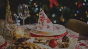 A Christmas plate and glass adorned with festive holiday decorations.