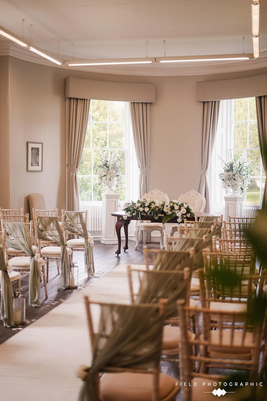 A wedding ceremony room with rows of decorated chairs, creating an elegant and festive atmosphere.