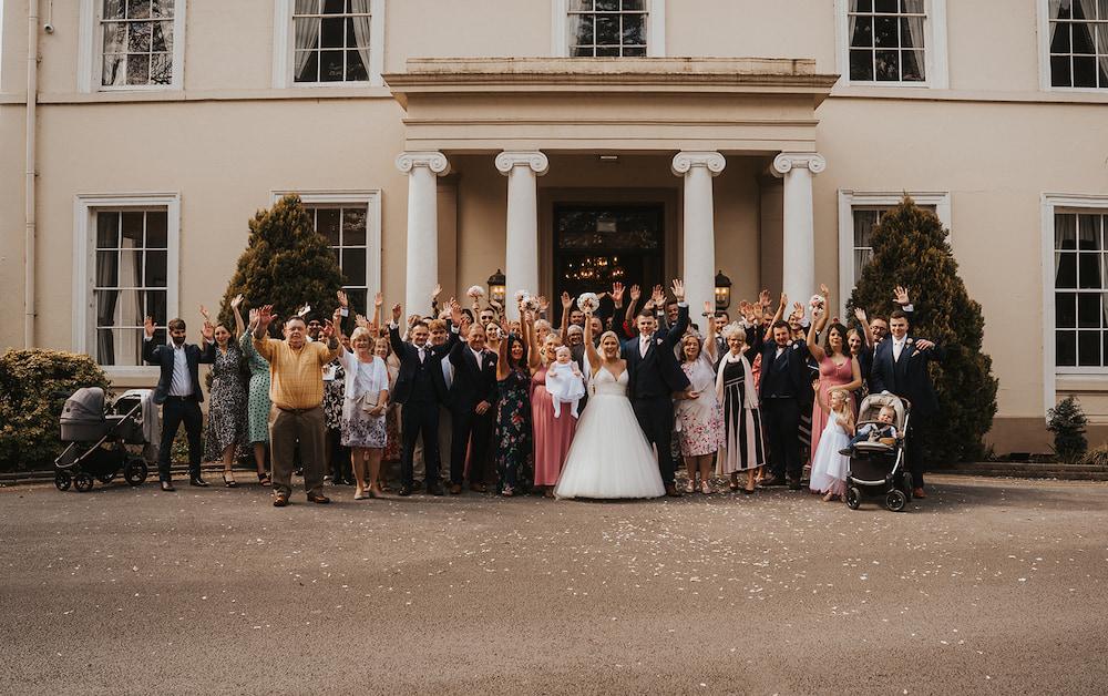 Group wedding photo outside Eastwood Hall.